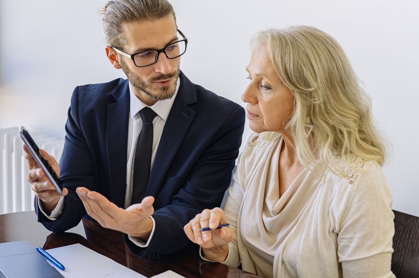 A registered tax agent explaining a document to a client across a desk